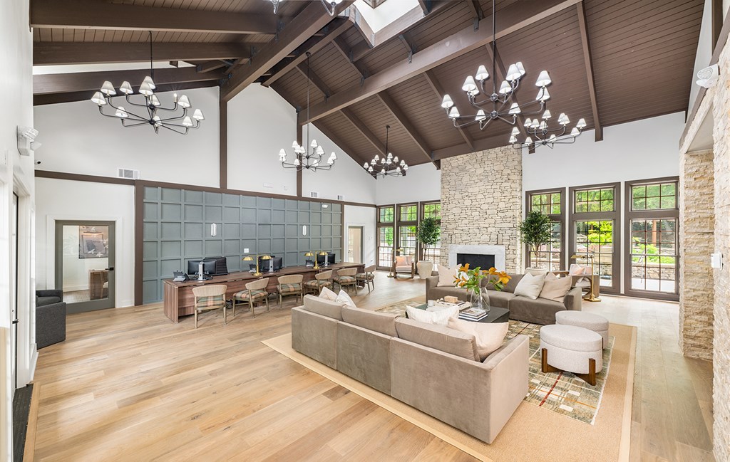 A spacious living room with a fireplace and a large couch.