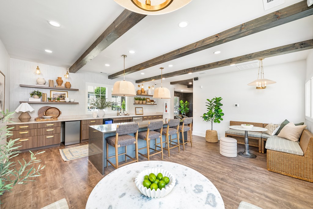 A modern kitchen with a dining area and a living area.