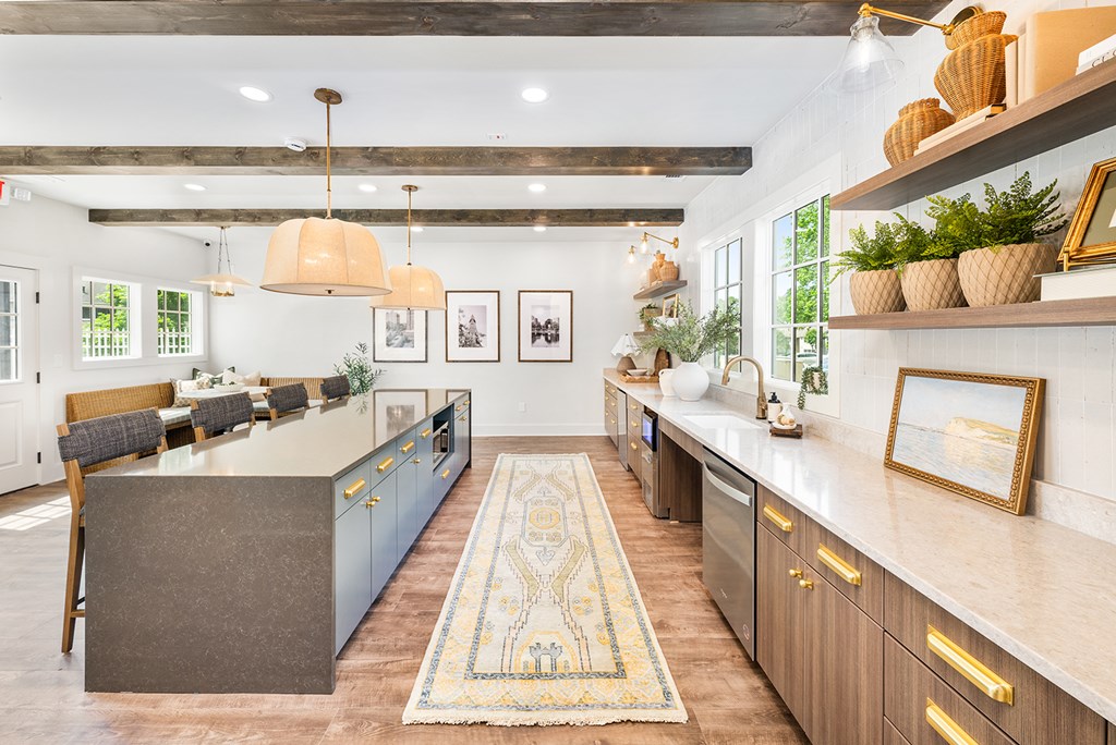 A kitchen with a large island and wooden cabinets.