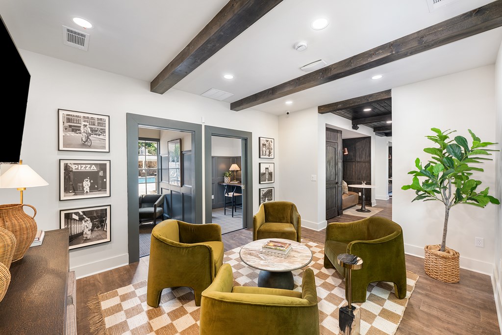 A living room with a checkered floor and a green chair.