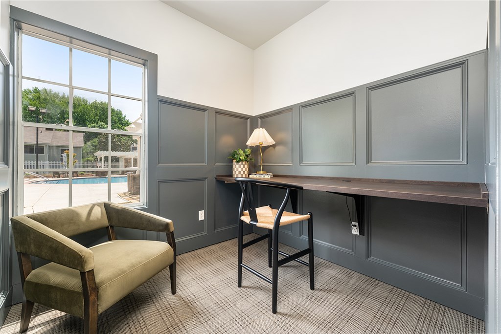 A room with a chair, a desk, and a lamp.
