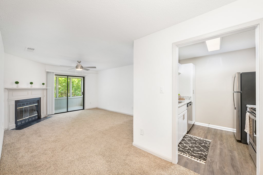 A living room with a fireplace and sliding glass doors.