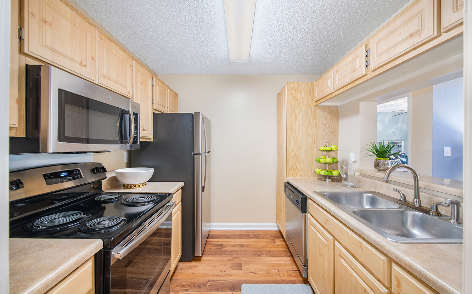 a kitchen with wooden cabinets and a black stove and refrigerator