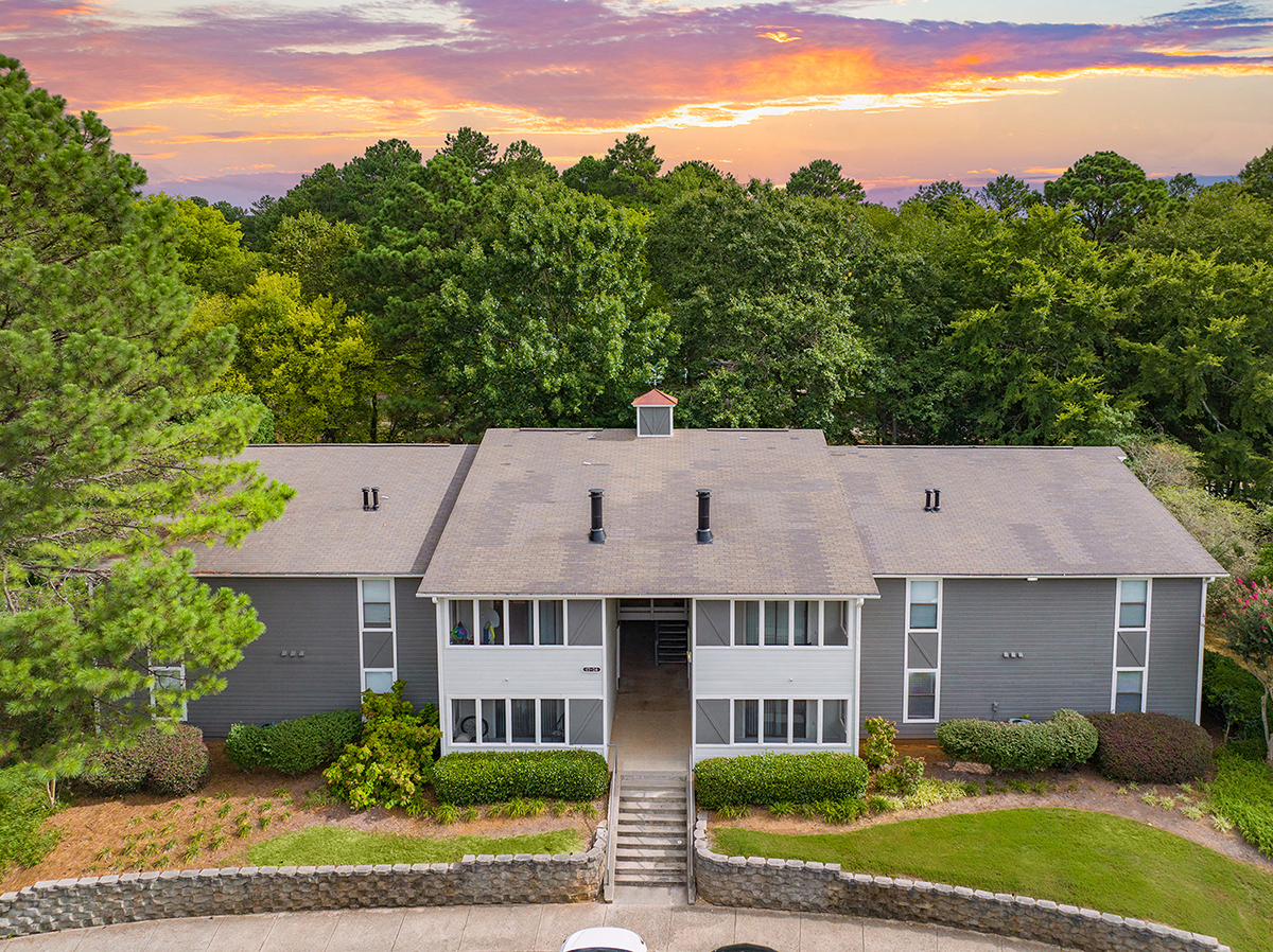 a large gray and with a sunset behind it