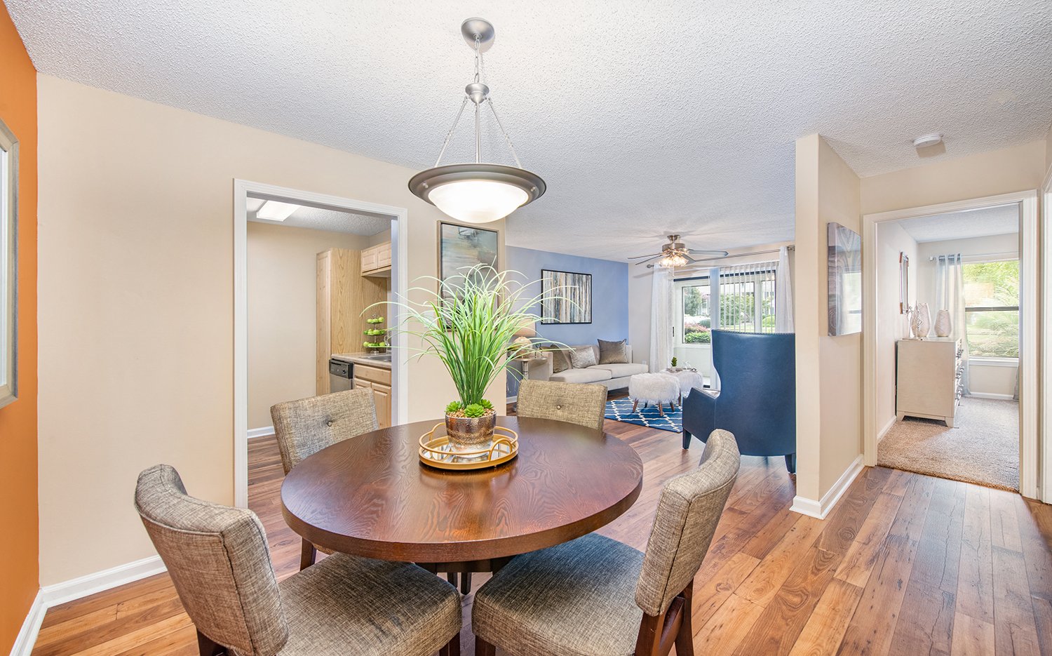 a dining room and living room with a table and chairs