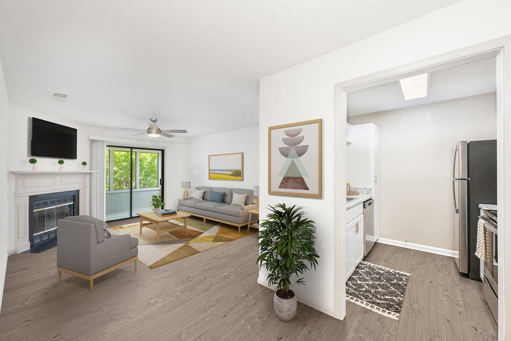 A living room with a grey couch and a fireplace.