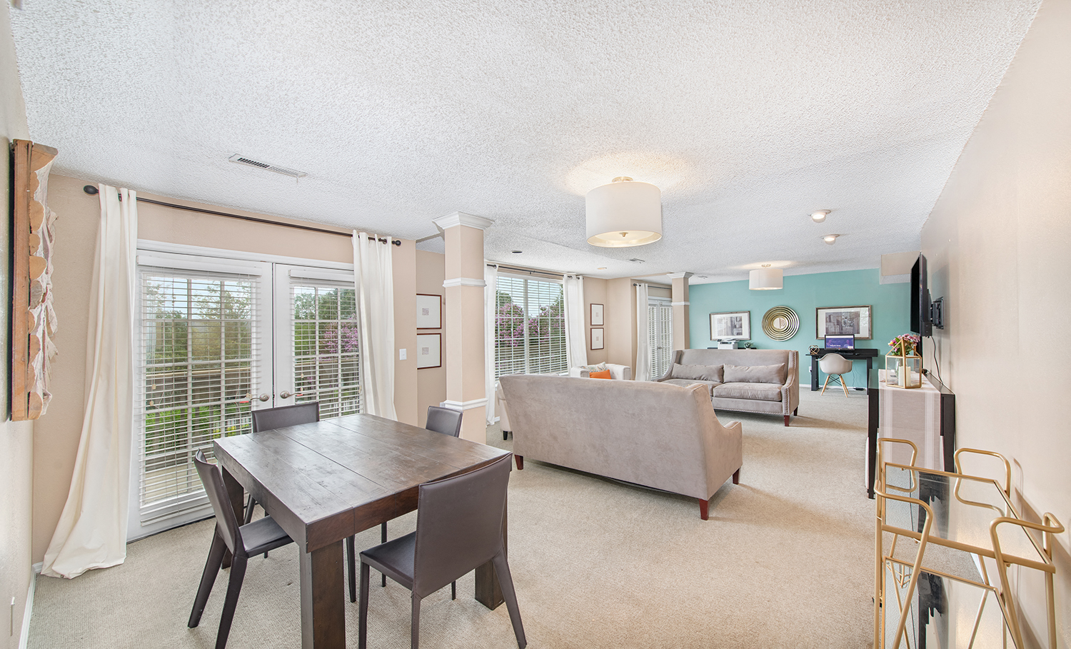a living room with a dining room table and a couch