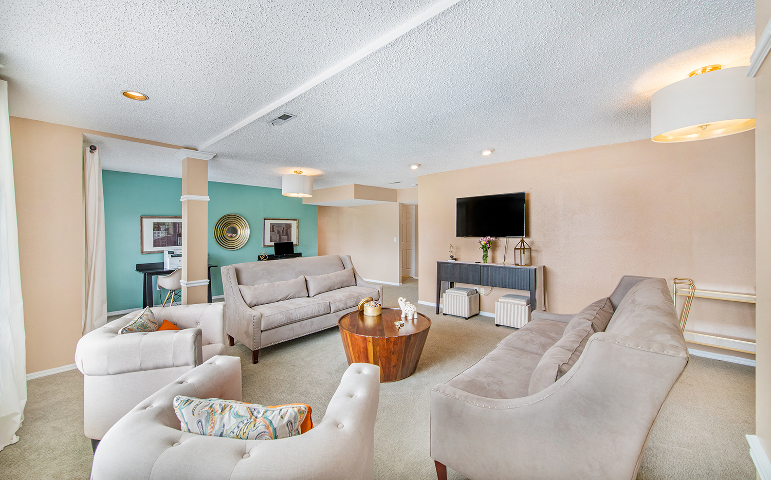 a living room with couches and chairs and a tv