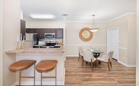 a kitchen and dining room with a table and chairs