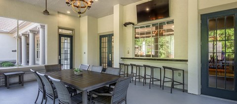 a dining room with a wooden table and chairs