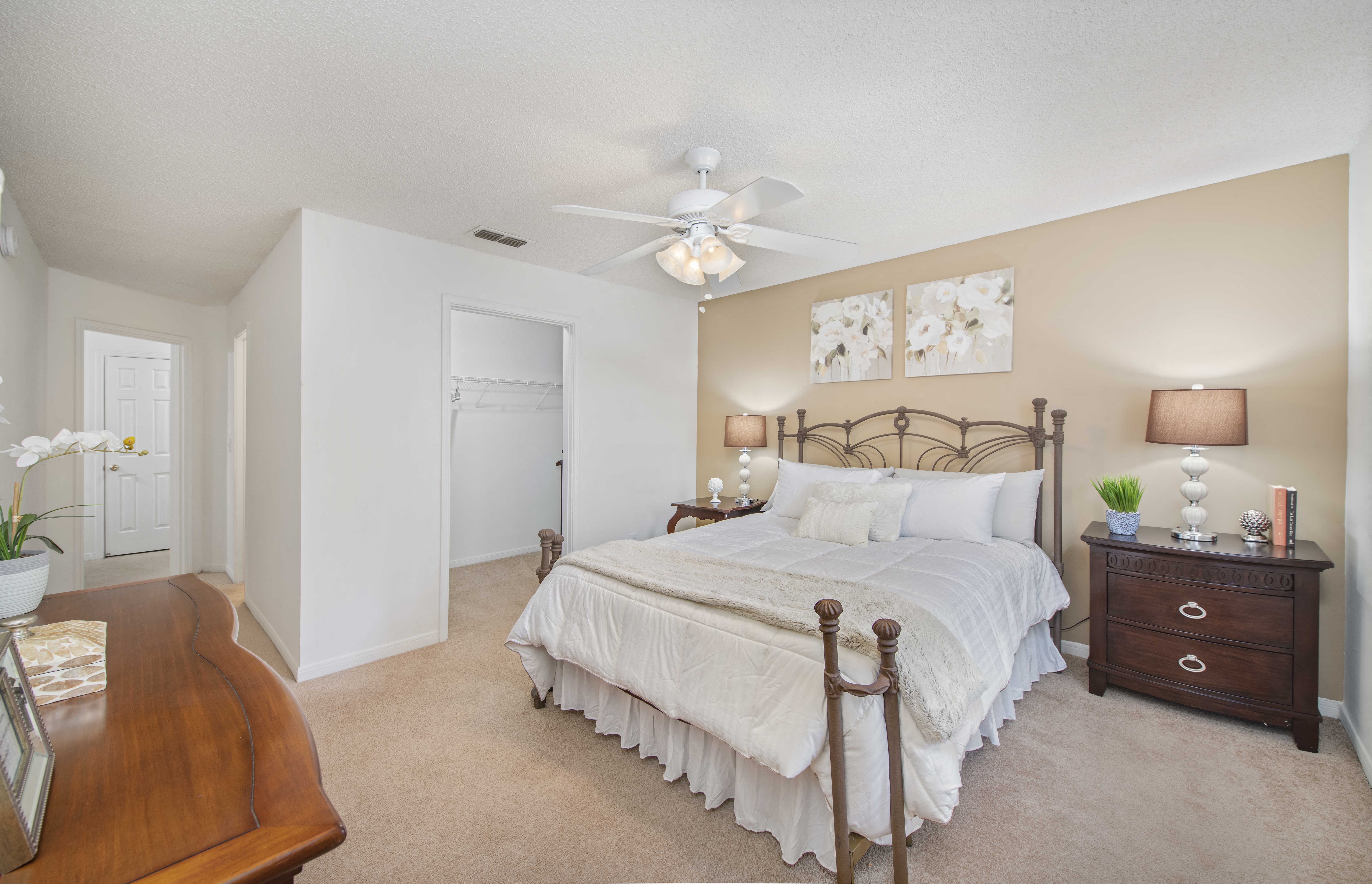a bedroom with a bed and a ceiling fan