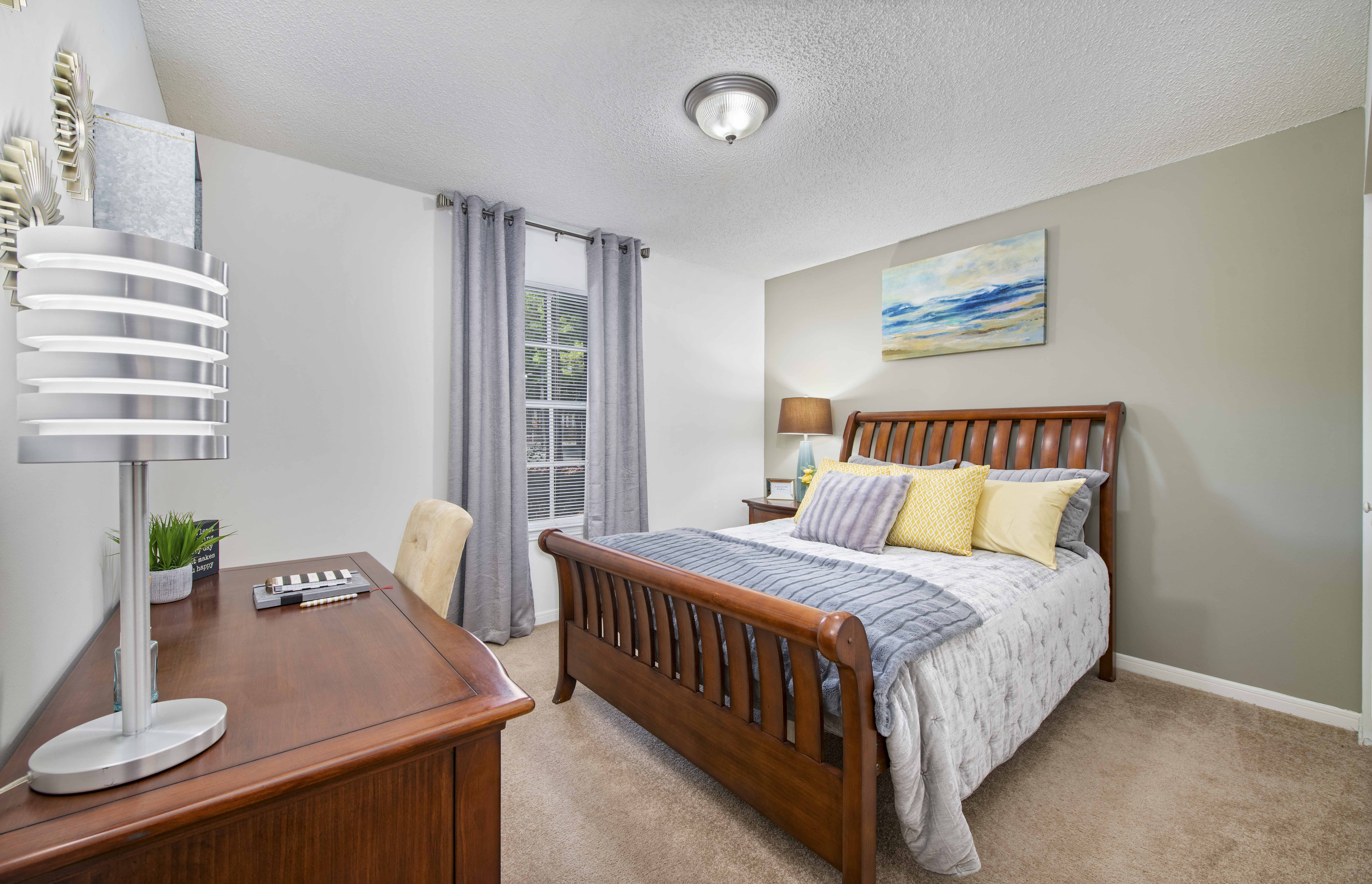 a bedroom with a bed and a desk