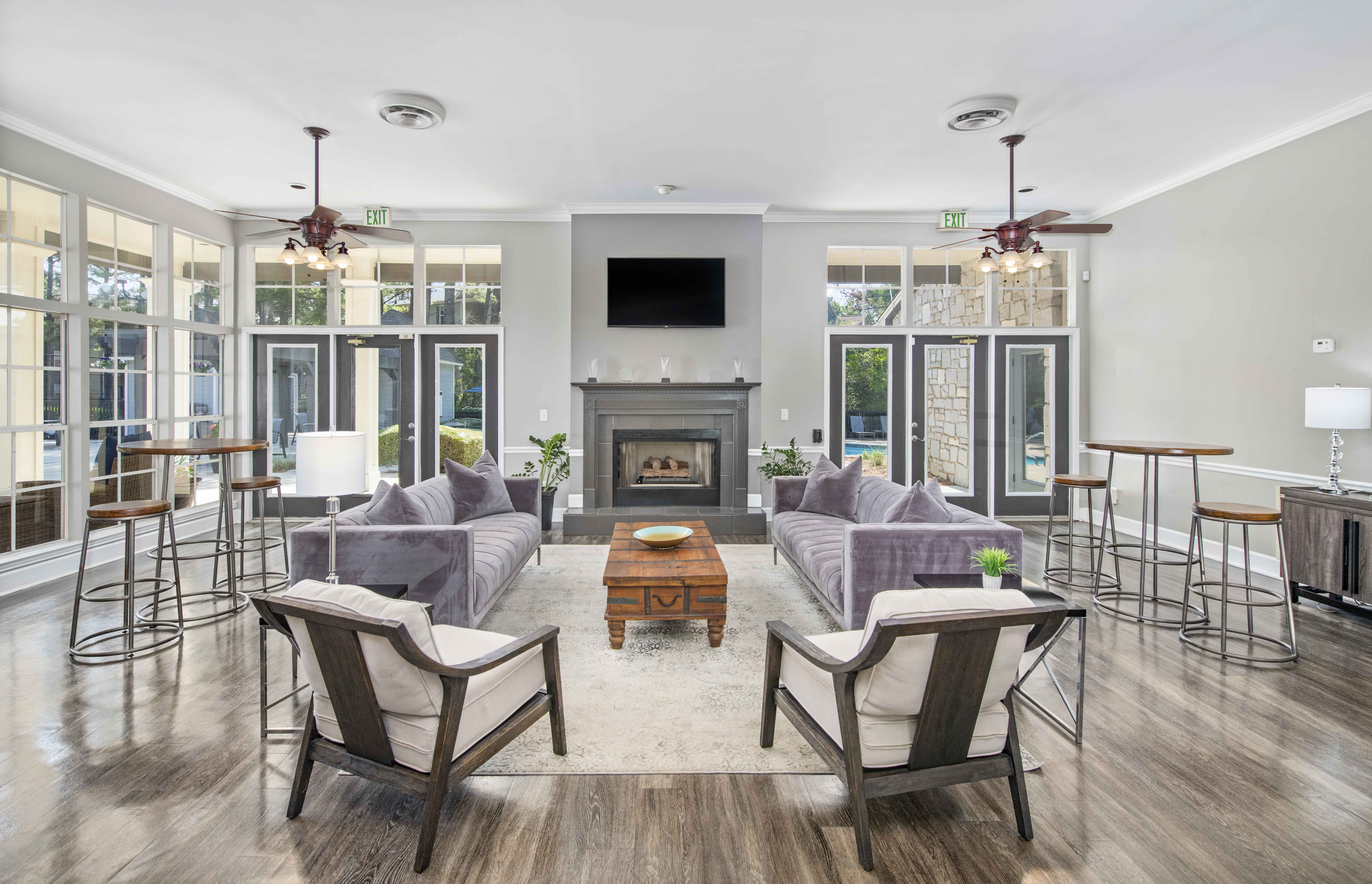 a living room with couches and chairs and a fireplace