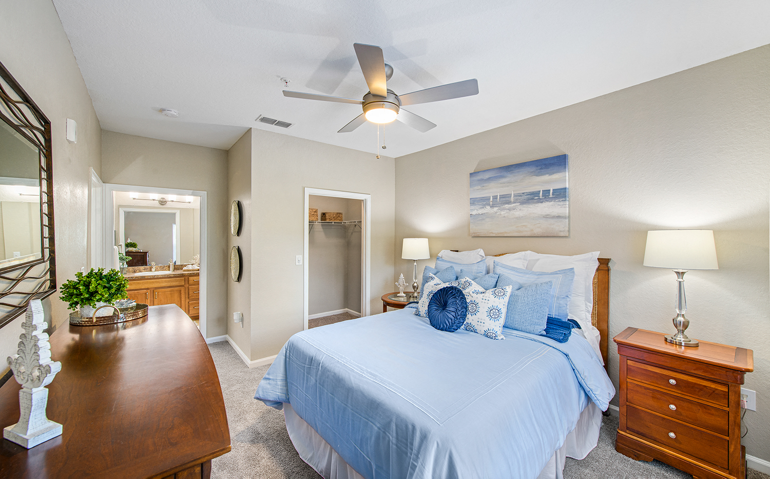 a bedroom with a large bed and a ceiling fan