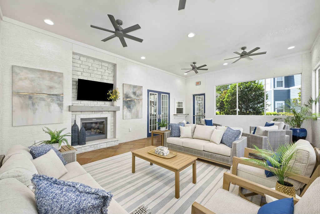 A living room with a fireplace and a TV mounted above it.