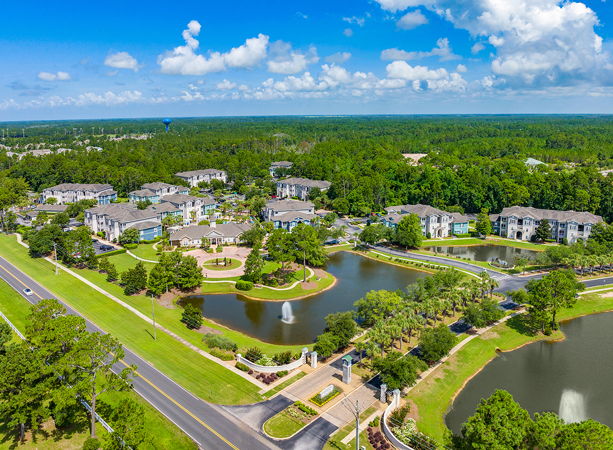 an aerial view of the community with a lake and houses