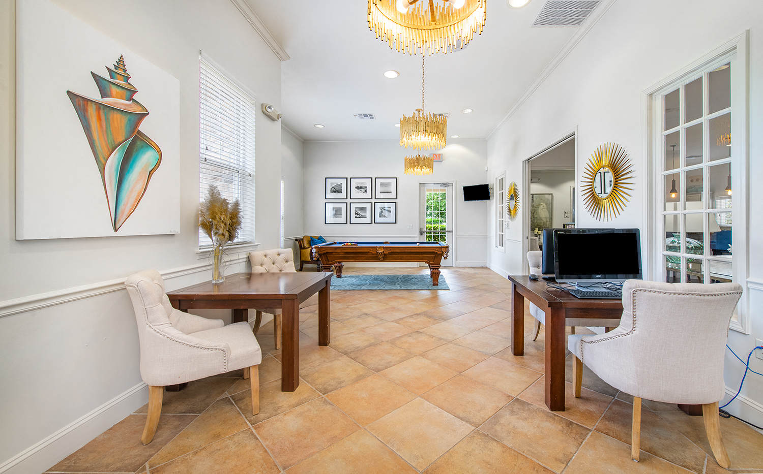 a living room with a table and chairs and a television