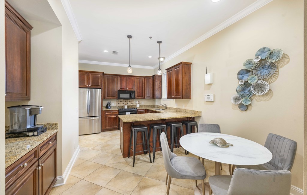 A kitchen with a table and chairs in the middle of it.