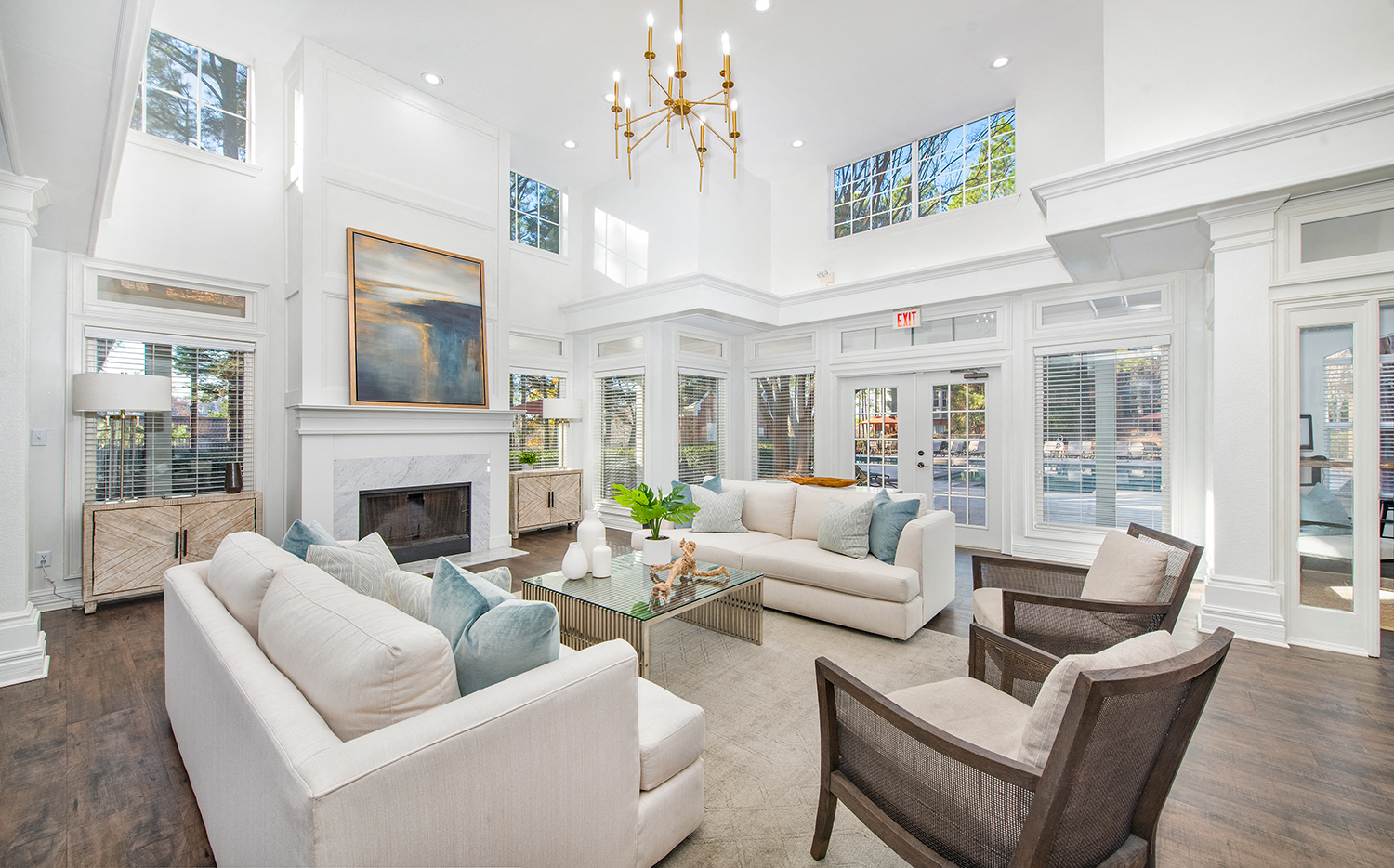 a living room with white furniture and a fireplace