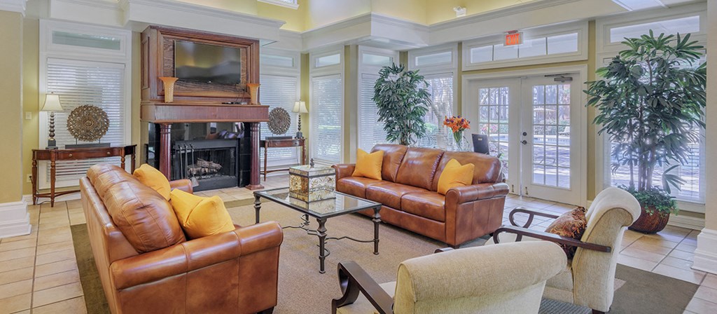 a living room with leather furniture and a fireplace