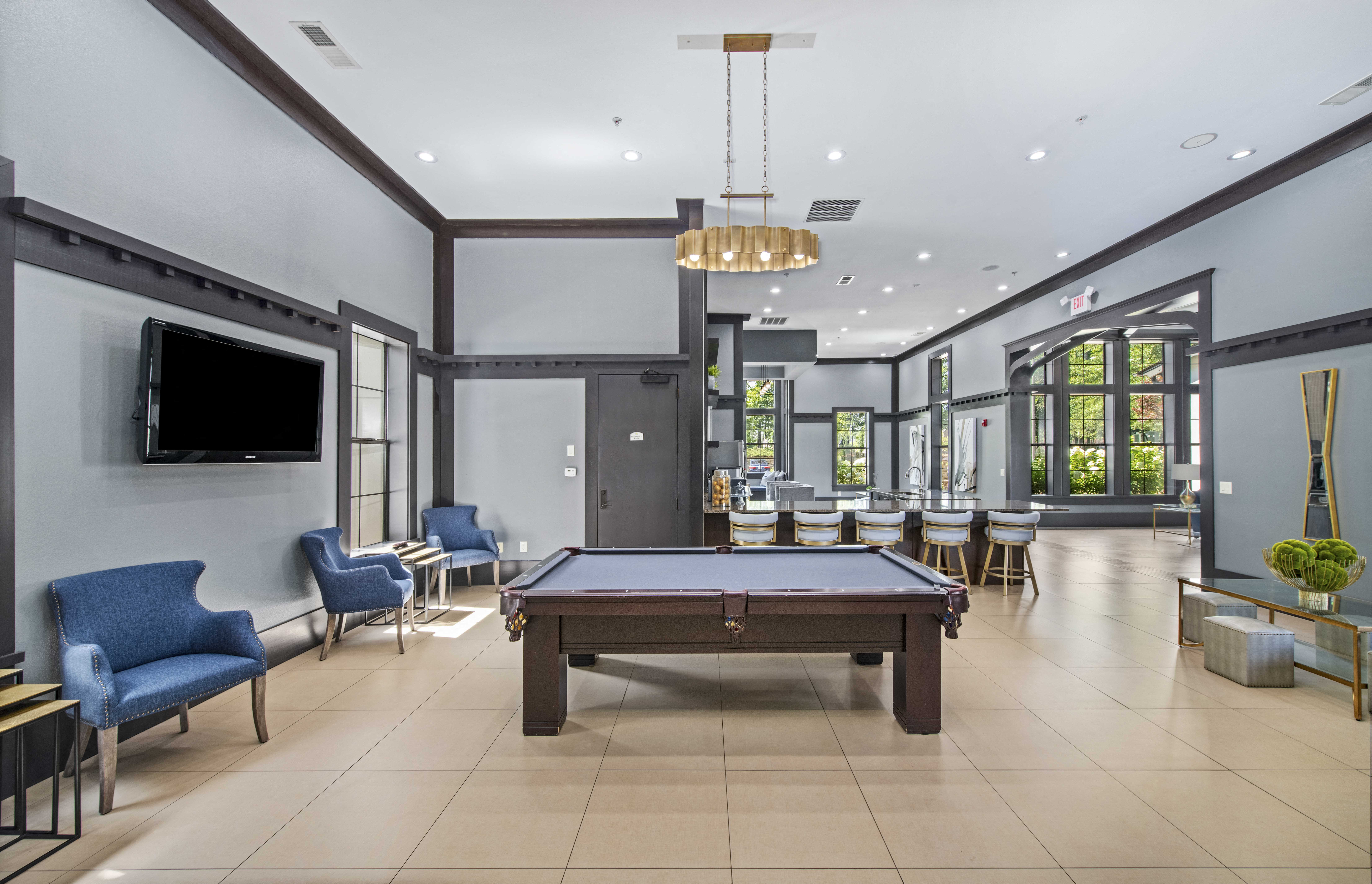 a clubhouse with a pool table and a tv