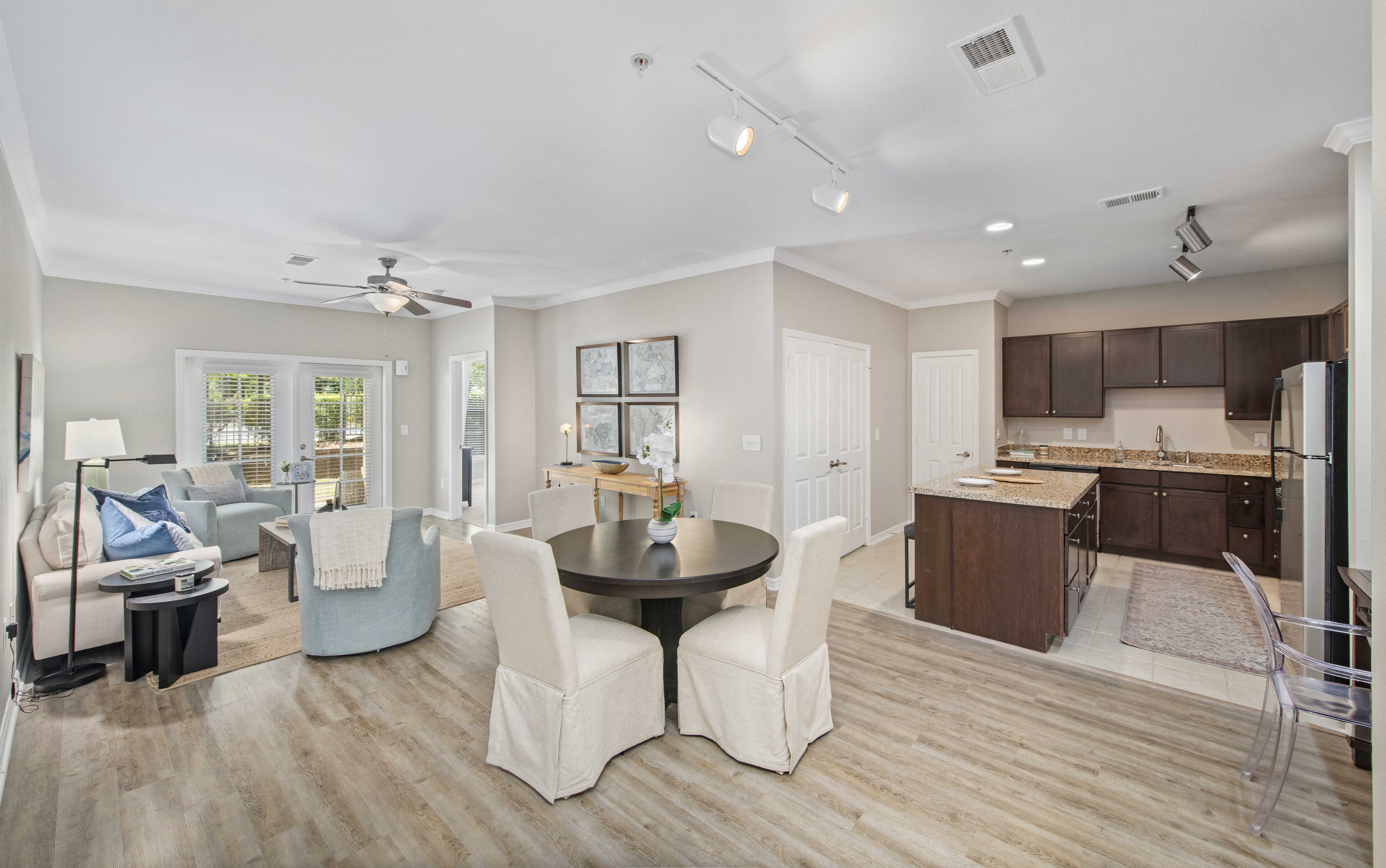 a living room with a kitchen and a dining table
