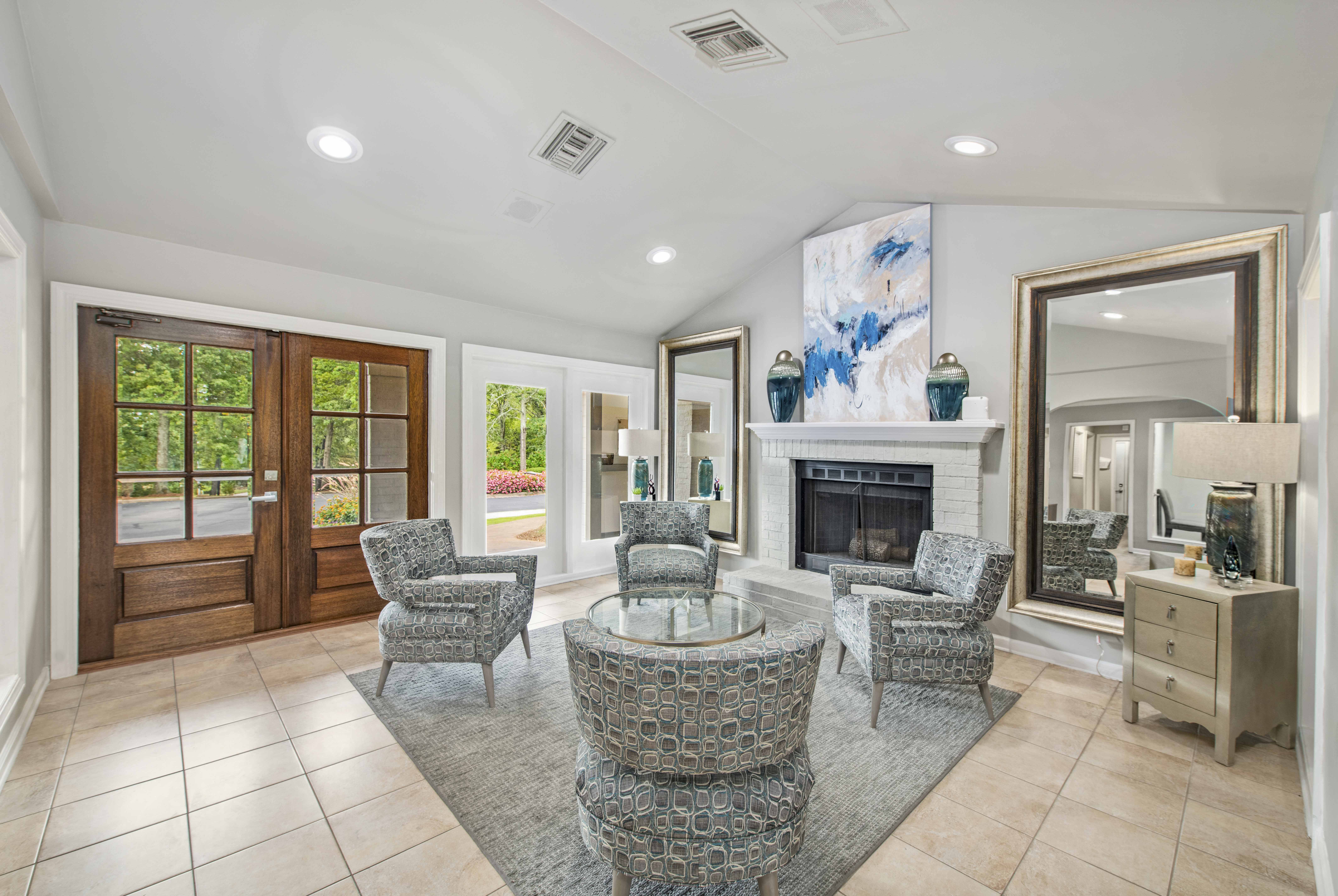 a living room with a fireplace and a table and chairs