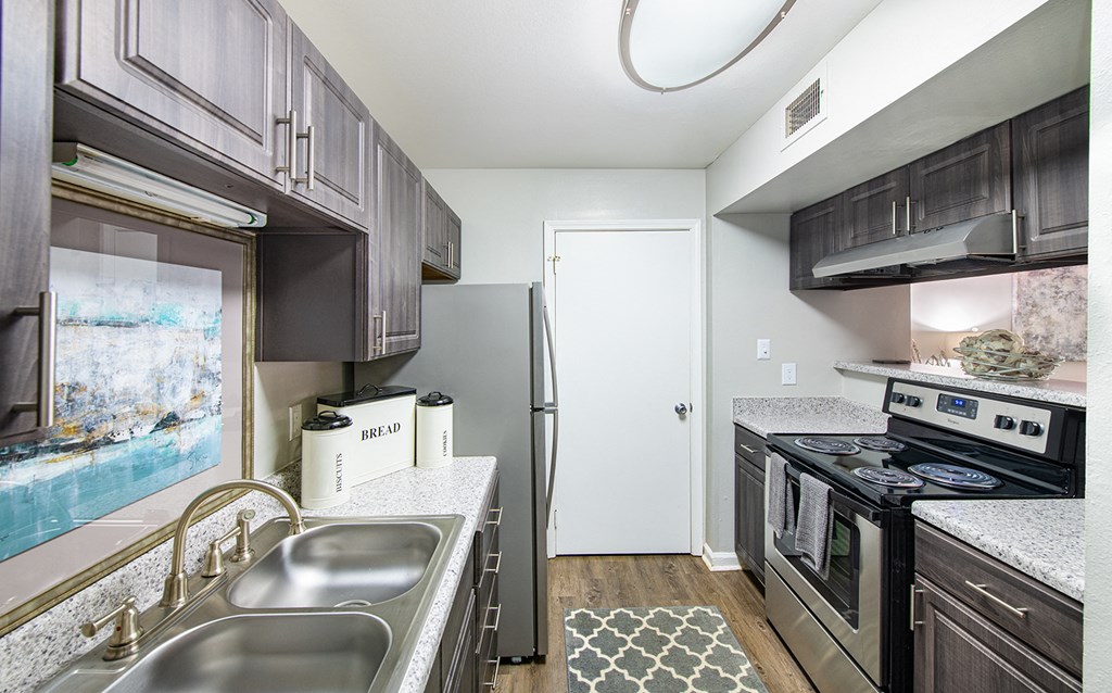 a kitchen with stainless steel appliances and granite counter tops