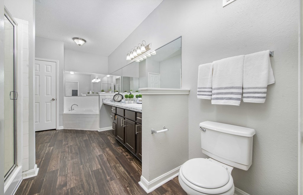 a white bathroom with a toilet and a sink