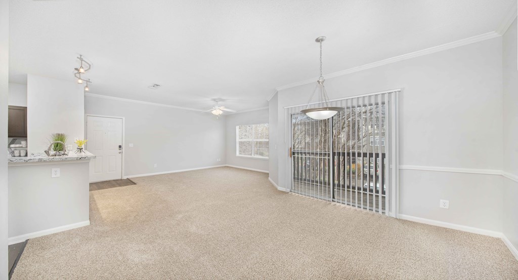 an empty living room with a gate in the middle