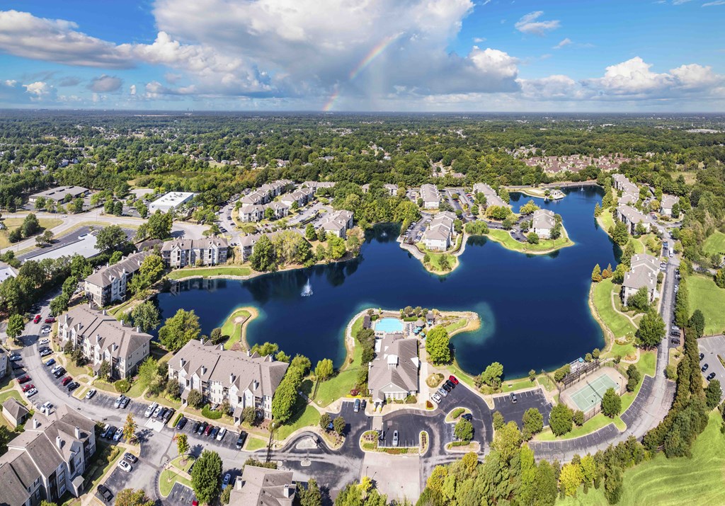 an aerial view of a community with a lake and houses