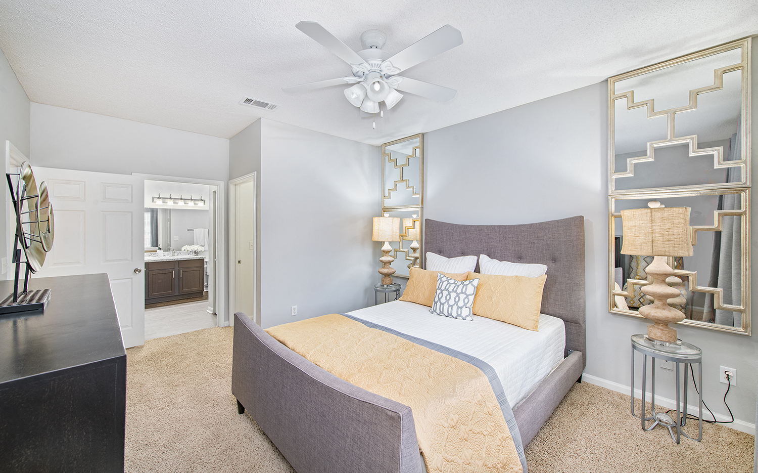 a bedroom with a large bed and a ceiling fan