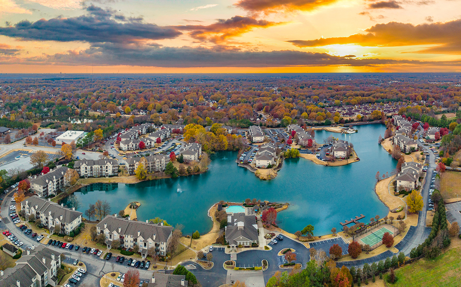 an aerial view of a small town with a blue lake