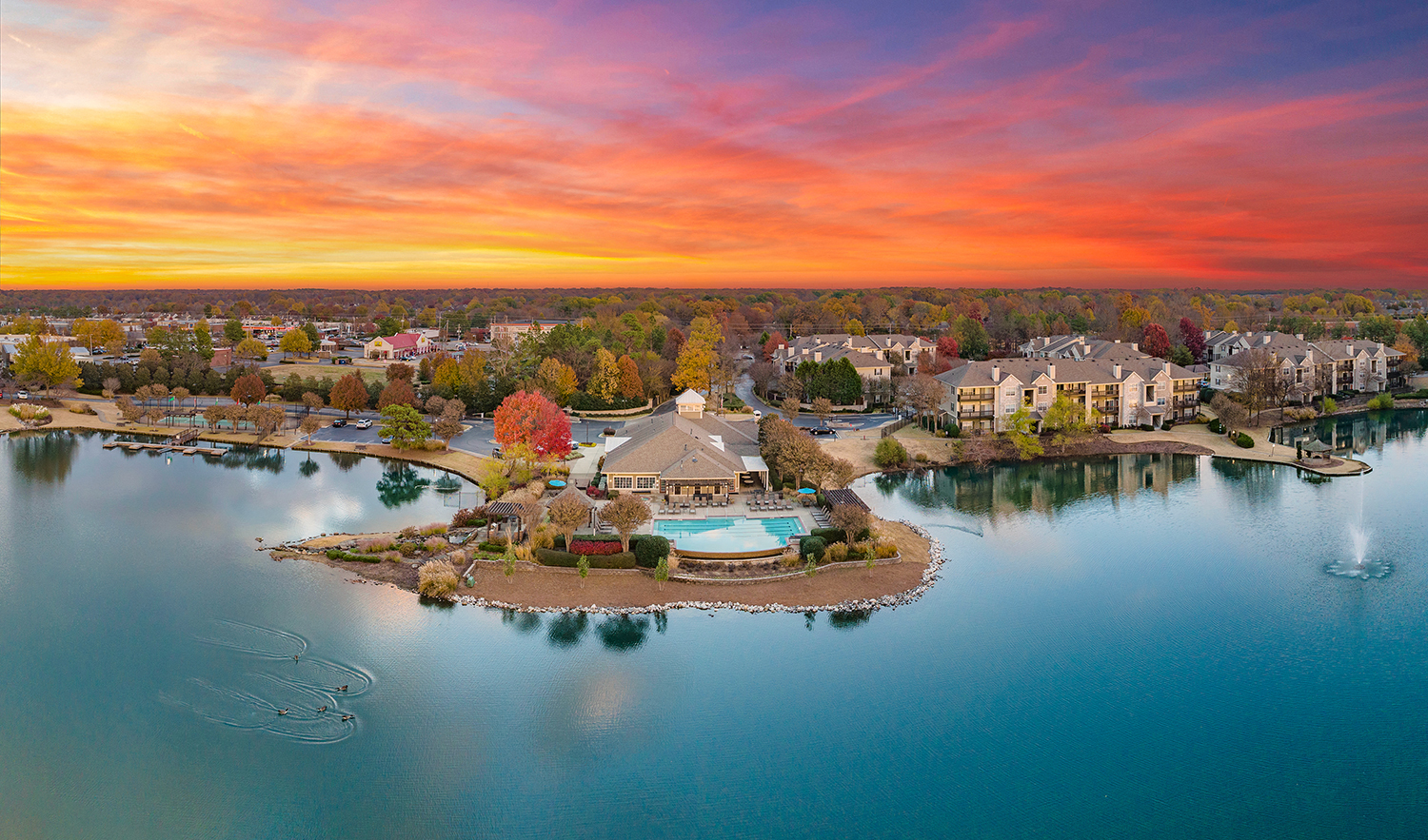 an aerial view of a resort on a small island in the middle of a lake