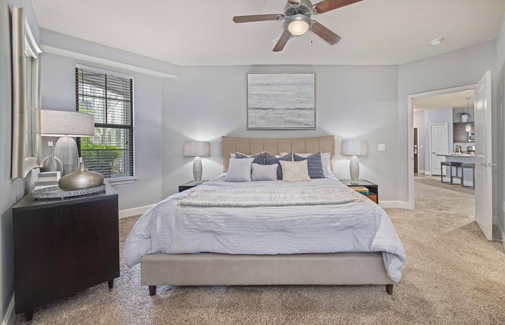 a bedroom with a bed and a ceiling fan