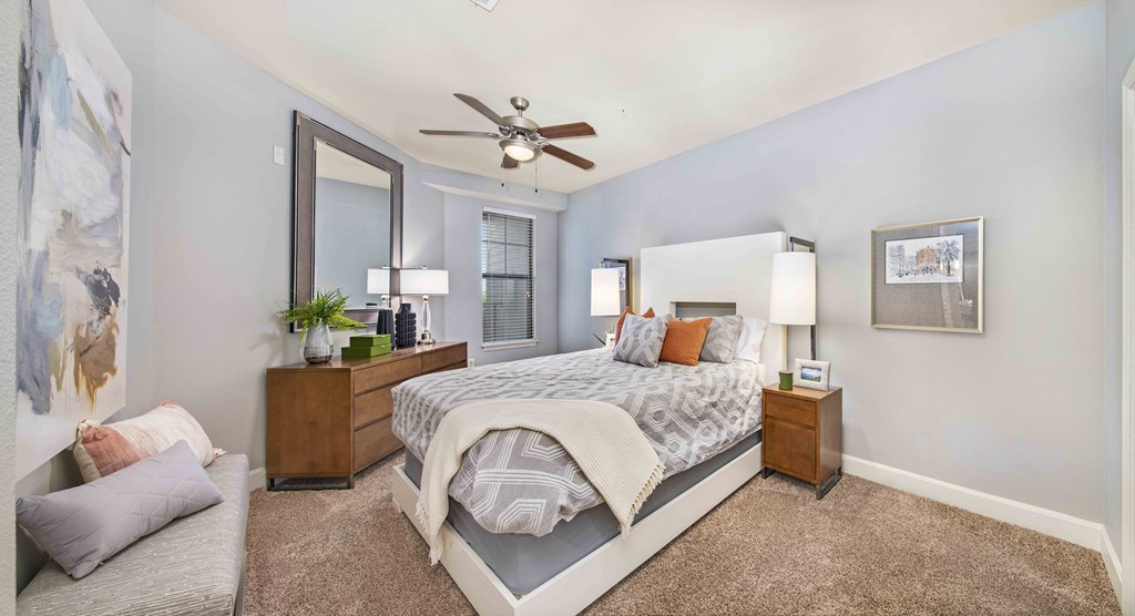 a bedroom with a bed and a ceiling fan