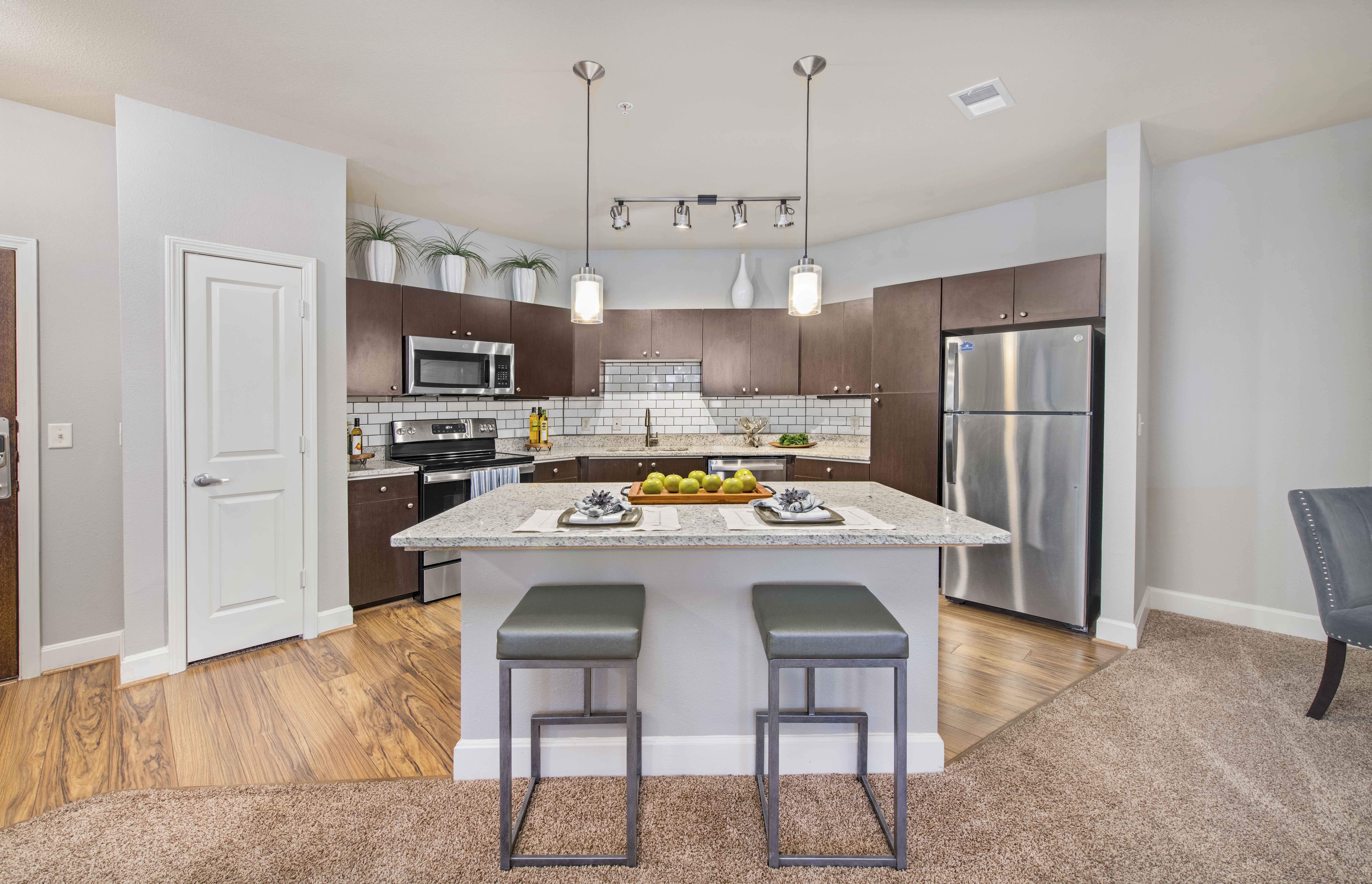 a kitchen with a marble counter top and stainless steel appliances