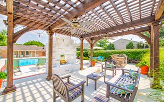 a patio with a pergola and a swimming pool