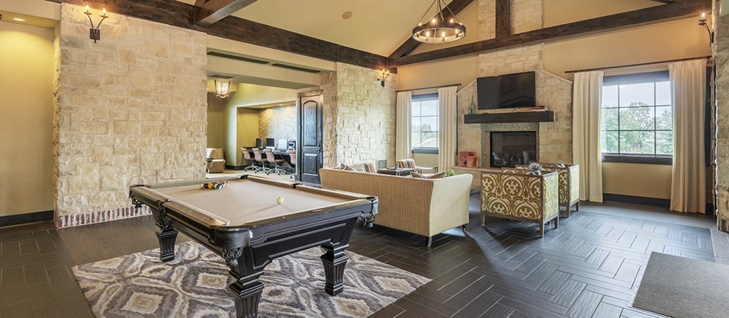 a game room with a pool table and a fireplace