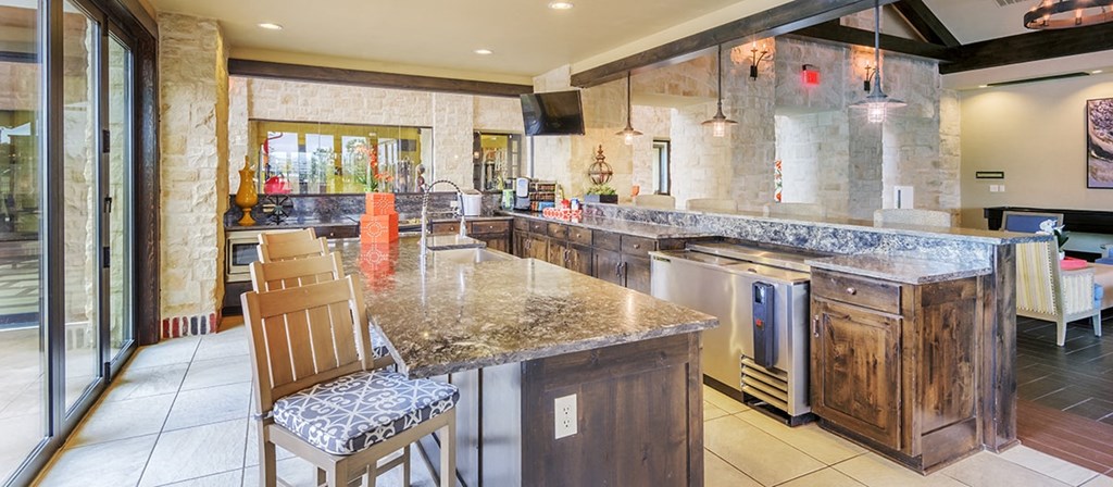 the kitchen has granite counter tops and stainless steel appliances