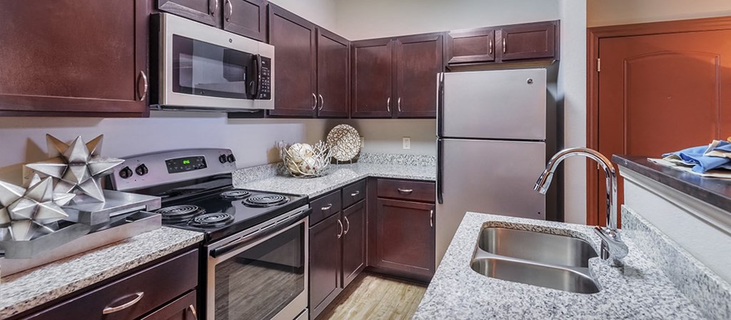a kitchen with stainless steel appliances and granite counter tops