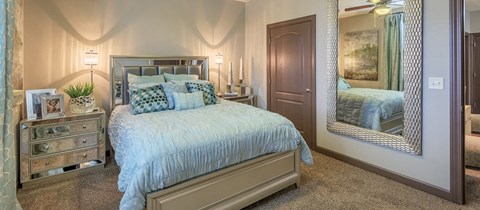 a bedroom with a bed and a mirror