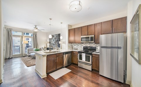 a kitchen with stainless steel appliances and wooden cabinets