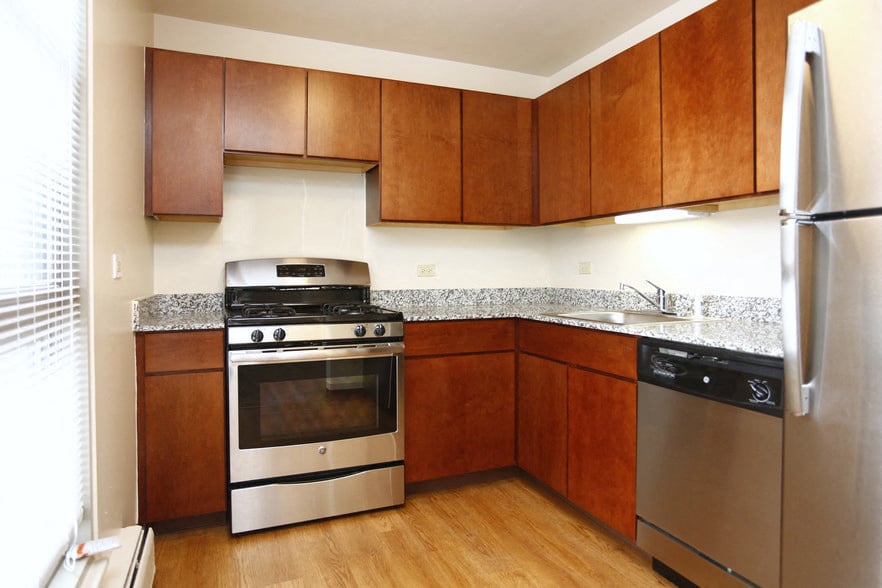 A kitchen with wooden cabinets and stainless steel appliances.