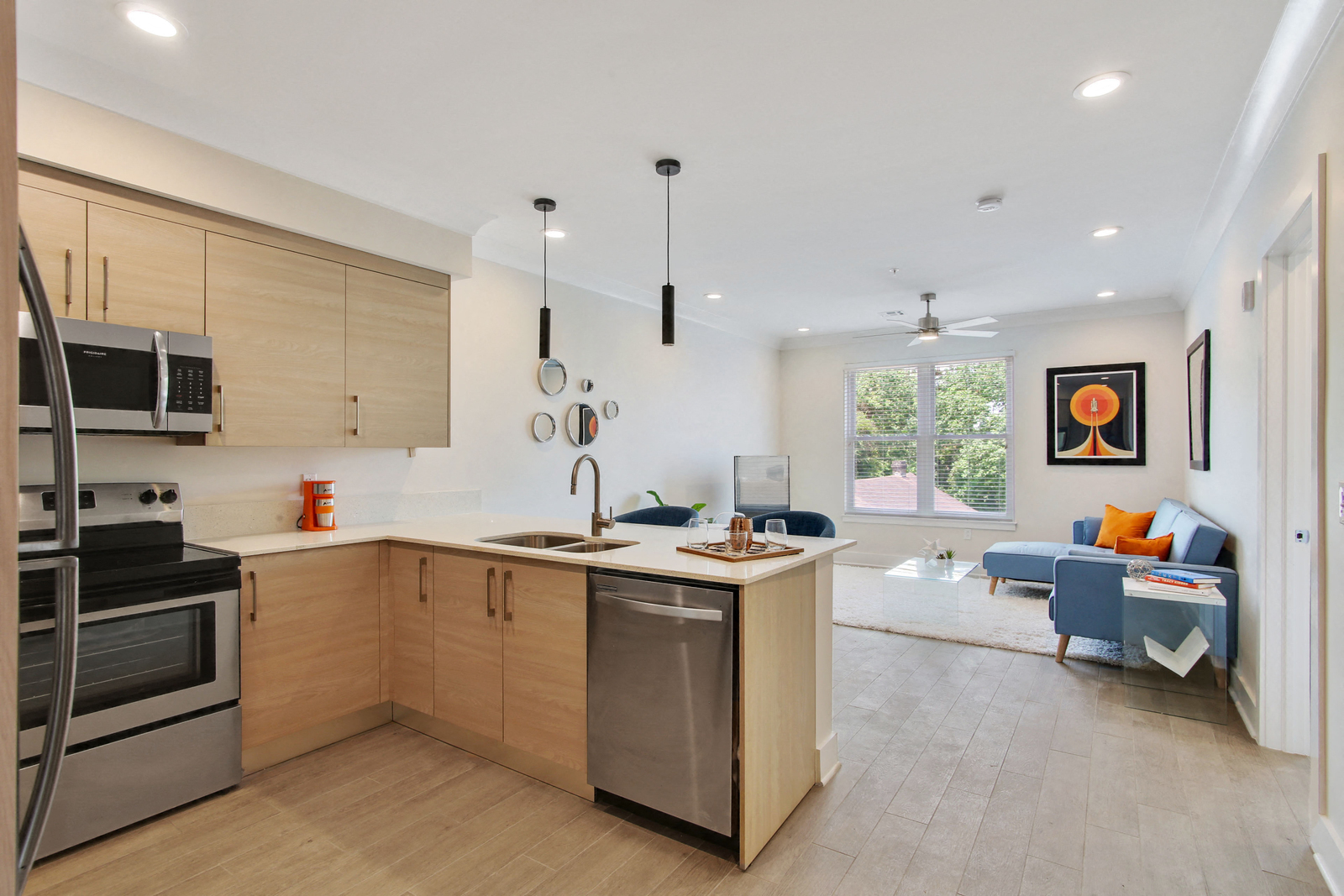 a kitchen with an island and a living room with a couch