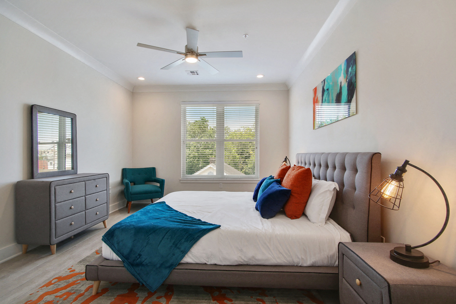 a bedroom with a bed and a ceiling fan