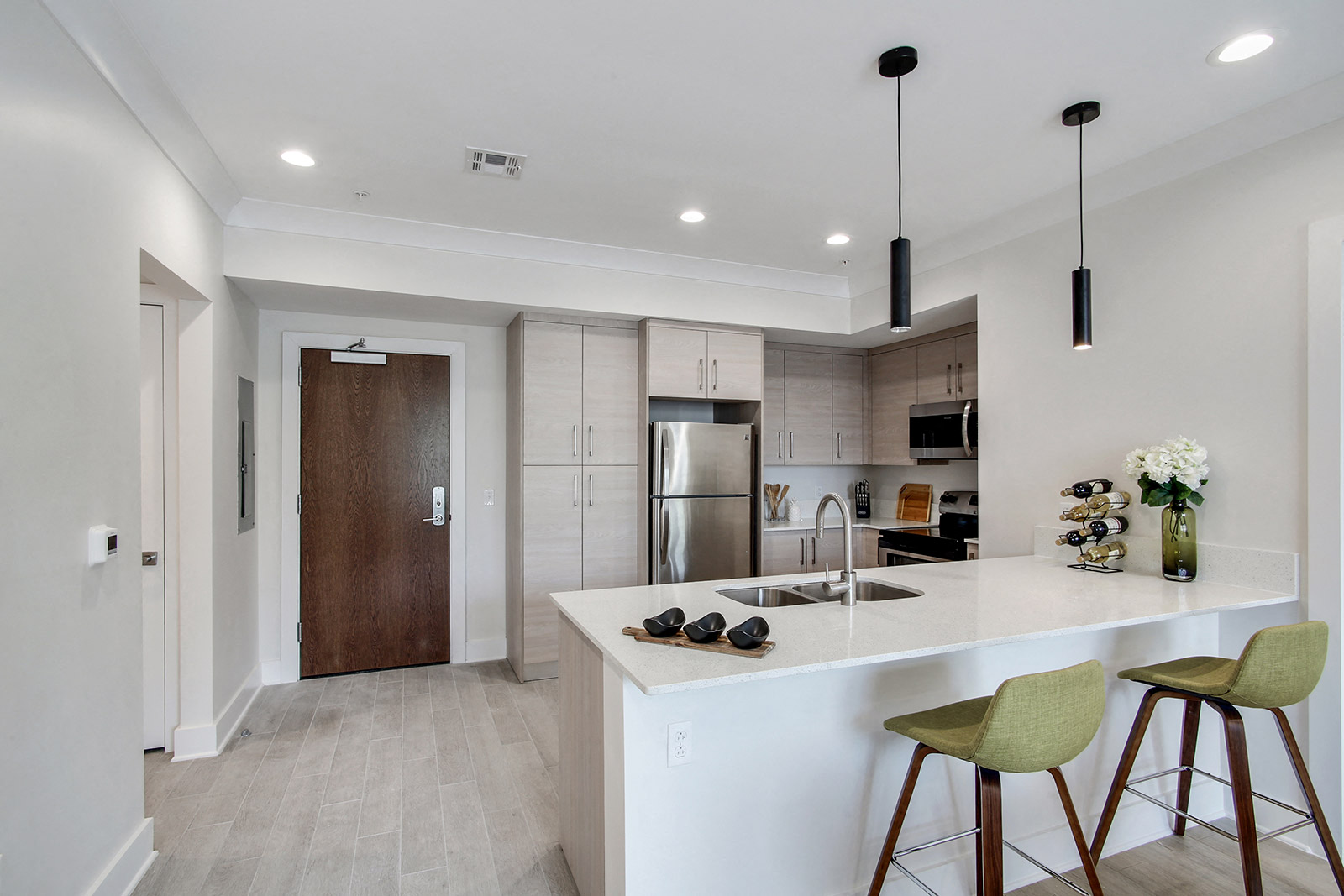 an open kitchen with a large island with bar stools