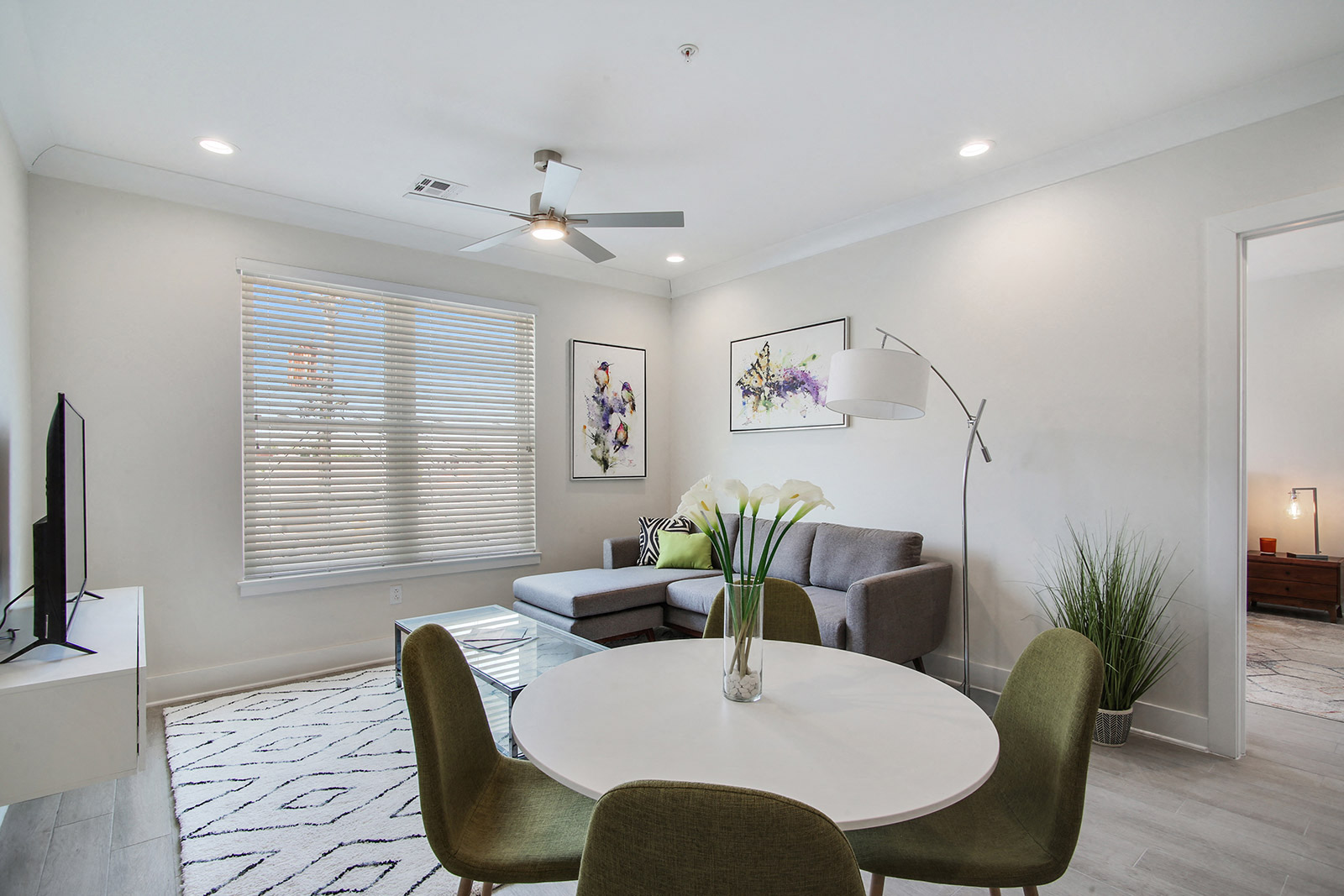 a living room with a round dining table and a couch