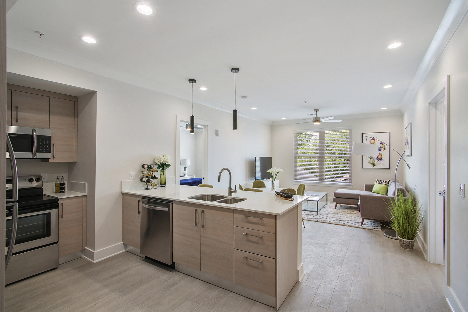 a kitchen with an island and a living room