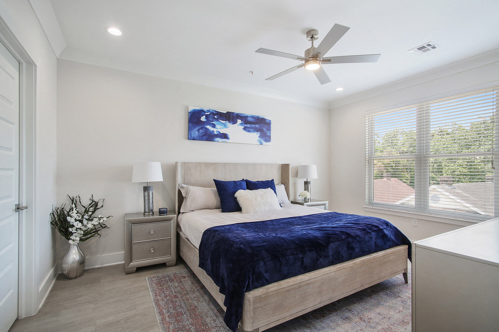 a bedroom with a bed and a ceiling fan